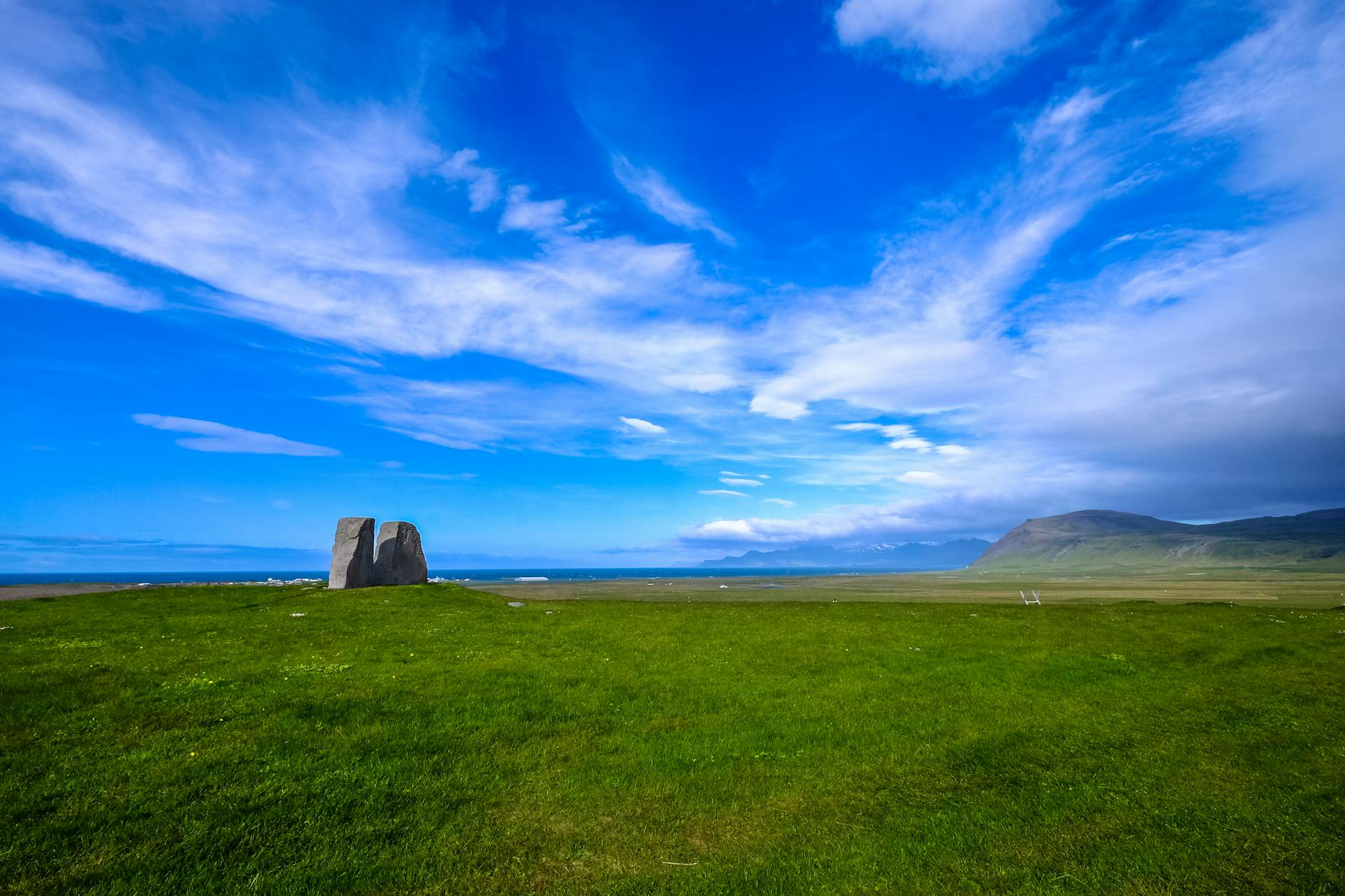 green grass field under blue sky