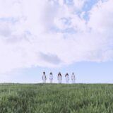 green grass field under white clouds